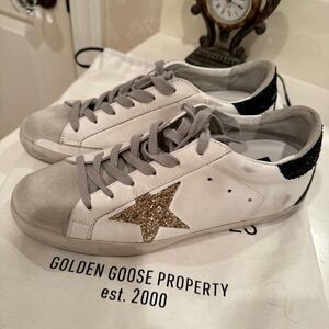 Golden Goose Super-Star with gold star and black glitter heel tab